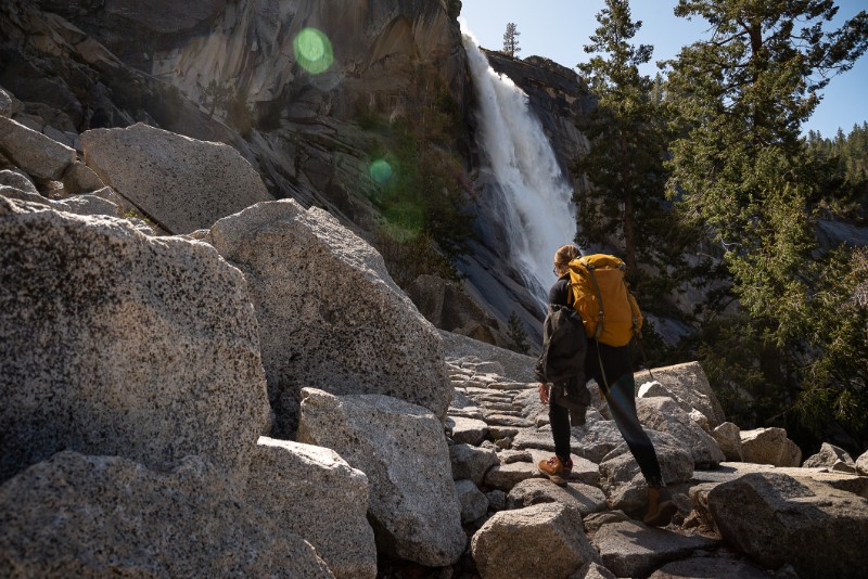 Woman by waterfall Nevada Fall in Yosemite National Park, California